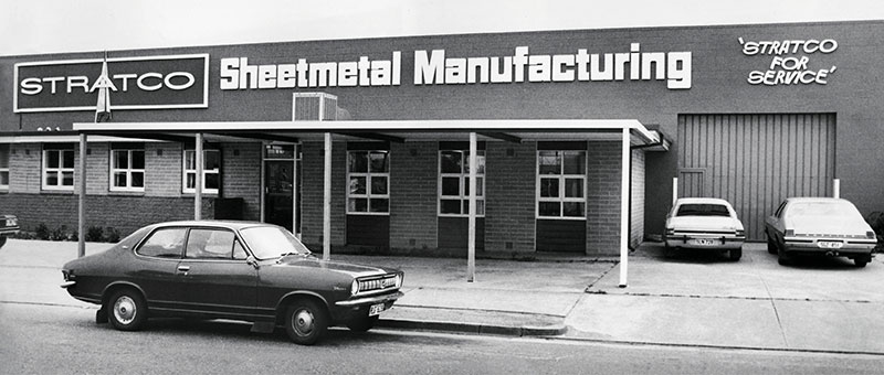 Stratco Sheet Metal Manufacturing Building - Black and White Stratco Sheet Metal Manufacturing Building with vintage car parked in front